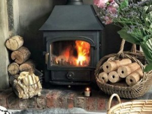 How is a wood burning stove with back boiler connected?